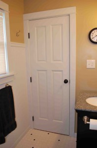 Purchased at an architectural outlet store, this bathroom door completes the clean, simple look and design of this master bathroom.